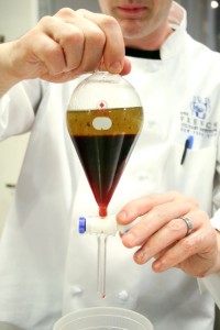 Dave using the separatory funnel to separate the oil from the brine.