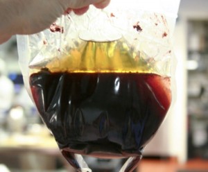 Olives straight out of the centrifuge: oil, brine, paste.