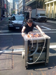 Dave holding up traffic on Grand Street as he pushes our new vacuum machine home.